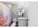 Cozy bathroom featuring a vanity with sink, and a charming unicorn-themed shower curtain for a whimsical touch at 26909 E Cedar Ave, Aurora, CO 80018