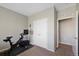Bedroom area featuring closet and exercise bike perfect for workouts at 26909 E Cedar Ave, Aurora, CO 80018