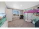 Bright bedroom with a modern loft bed, cozy beanbag chairs, and a large window offering neighborhood views at 26909 E Cedar Ave, Aurora, CO 80018