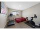 Bedroom with American flag art, treadmill and exercise bike for at-home workouts at 26909 E Cedar Ave, Aurora, CO 80018