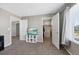 Neutral bedroom featuring plush carpeting, a walk-in closet, and a bright window, creating a cozy and inviting space at 26909 E Cedar Ave, Aurora, CO 80018