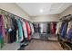 Walk-in closet featuring extensive hanging space, built-in drawers, and shelving for optimum storage and organization at 26909 E Cedar Ave, Aurora, CO 80018