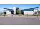 Stylish community clubhouse with modern architecture, ample parking, and inviting outdoor seating areas at 26909 E Cedar Ave, Aurora, CO 80018