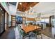 Spacious clubhouse dining area with a large wooden table, modern lighting, and access to a gourmet kitchen at 26909 E Cedar Ave, Aurora, CO 80018