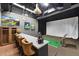 Modern golf simulator setup with seating for several people at 26909 E Cedar Ave, Aurora, CO 80018