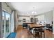 Spacious kitchen with stainless steel appliances, a large island, and an adjacent dining area for seamless entertaining and Gathering meals at 26909 E Cedar Ave, Aurora, CO 80018