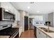 Modern kitchen featuring stainless steel appliances, granite countertops, and white cabinetry for a bright and clean design at 26909 E Cedar Ave, Aurora, CO 80018