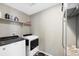 Laundry room features a washer, dryer, shelving, and extra storage at 26909 E Cedar Ave, Aurora, CO 80018