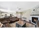 Cozy living room with a stone fireplace and hardwood floors, with an open view to the adjacent kitchen, creating a great flow at 26909 E Cedar Ave, Aurora, CO 80018