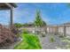 Beautifully landscaped backyard with lush greenery, decorative rocks, and a well-maintained fence for privacy at 2932 Eagle Wing Way, Castle Rock, CO 80109