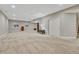 Expansive basement boasts soft carpet, neutral walls, and recessed lighting, offering a blank canvas for customization at 2932 Eagle Wing Way, Castle Rock, CO 80109