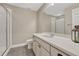 This modern bathroom features gray floors, and a bright vanity area next to a glass shower at 2932 Eagle Wing Way, Castle Rock, CO 80109