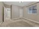 This bedroom features soft carpet, neutral walls, and a window, and easy access to the hall and closet at 2932 Eagle Wing Way, Castle Rock, CO 80109