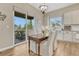 Bright dining area featuring a wooden table, stylish chairs, and a sliding glass door to the outside patio at 2932 Eagle Wing Way, Castle Rock, CO 80109