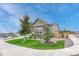 Well-maintained home exterior with a manicured front yard, mature trees, and attractive landscaping features at 2932 Eagle Wing Way, Castle Rock, CO 80109