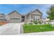 Charming single-Gathering home with a well-manicured lawn, stone accents, and a two-car garage at 2932 Eagle Wing Way, Castle Rock, CO 80109