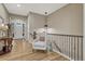 Hallway with hardwood floors and a grey chair at 2932 Eagle Wing Way, Castle Rock, CO 80109