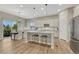 Open-concept kitchen with stainless steel appliances, a center island, and hardwood floors at 2932 Eagle Wing Way, Castle Rock, CO 80109
