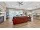 Open-concept living room with a fireplace, large windows with coverings, and hardwood floors at 2932 Eagle Wing Way, Castle Rock, CO 80109