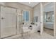 Bright bathroom features tub, tiled shower with glass door, and a seat at 2932 Eagle Wing Way, Castle Rock, CO 80109