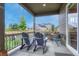Inviting covered patio with stylish Adirondack chairs and outdoor seating, perfect for relaxing or entertaining at 2932 Eagle Wing Way, Castle Rock, CO 80109