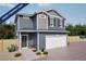 Charming two-story home featuring blue siding, a white garage door, and professionally landscaped front yard at 46505 Sunflower Ln, Bennett, CO 80102