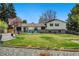 Lush backyard with mature trees, patio furniture, and well-kept lawn, perfect for outdoor enjoyment and entertaining at 6439 E Maplewood Ave, Centennial, CO 80111