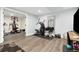 Basement home gym with modern exercise equipment, wood-look flooring, mirror, and additional space for activities at 6439 E Maplewood Ave, Centennial, CO 80111