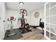 Basement gym featuring stationary bike, Bowflex machine, rowing machine, and modern exercise equipment on rubber flooring at 6439 E Maplewood Ave, Centennial, CO 80111