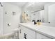 Bright bathroom features a white vanity, modern fixtures, and a shower with white subway tile at 6439 E Maplewood Ave, Centennial, CO 80111