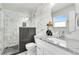 Modern bathroom features stylish tile work in the shower and a sleek vanity with a granite countertop at 6439 E Maplewood Ave, Centennial, CO 80111