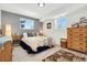 Cozy bedroom featuring plush carpeting, bedside tables, and a comfortable bed with decorative pillows and floral comforter at 6439 E Maplewood Ave, Centennial, CO 80111