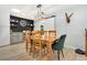 Dining area showcasing a wooden table and chairs, trendy lighting, and modern serving area with a beverage cooler at 6439 E Maplewood Ave, Centennial, CO 80111