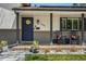 Cozy front porch with rocking chairs and a charming sunflower wreath on the door at 6439 E Maplewood Ave, Centennial, CO 80111