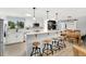 Modern kitchen with white cabinets, stainless steel appliances, and breakfast bar at 6439 E Maplewood Ave, Centennial, CO 80111