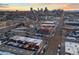 Aerial view capturing the Denver skyline, cityscape, streets, and surrounding neighborhood in a warm sunset glow at 1235 31St St, Denver, CO 80205