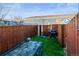 Fenced backyard featuring artificial grass, a tiled area, and a grill at 1235 31St St, Denver, CO 80205