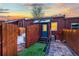 Backyard features artificial grass, a tiled patio, and wooden fences with the rear entrance to the home at 1235 31St St, Denver, CO 80205