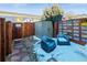 Backyard patio with seating, storage shed and decorated with hanging decorative lights at 1235 31St St, Denver, CO 80205