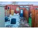 Rear patio with outdoor seating on a snowy day; wood fences and a blue back door at 1235 31St St, Denver, CO 80205