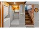 Basement area with laundry, white painted brick, and stairs to the main level features a dart board for entertainment at 1235 31St St, Denver, CO 80205