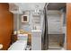 Modern bathroom with a floating sink, tub, and uniquely styled white painted brick walls and cork accents at 1235 31St St, Denver, CO 80205