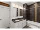 This bathroom features a granite countertop with double sinks and a bathtub with modern dark tiling at 1235 31St St, Denver, CO 80205