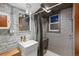 Features a modern bathroom with a rain shower, floating sink, and white painted brick walls adding a touch of urban style at 1235 31St St, Denver, CO 80205