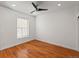 Minimalist bedroom with hardwood floors, a window with blinds, and neutral wall paint at 1235 31St St, Denver, CO 80205