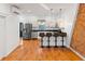 Modern kitchen with stainless steel appliances, a breakfast bar, and ample counter space at 1235 31St St, Denver, CO 80205