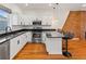 Bright kitchen featuring white cabinetry, stainless steel appliances, and granite countertops at 1235 31St St, Denver, CO 80205