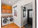 A laundry room with front load washer and dryer plus wooden cabinets and counter space at 1235 31St St, Denver, CO 80205