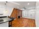 Bright, open living area with wood floors, a brick accent wall, and modern lighting at 1235 31St St, Denver, CO 80205