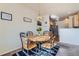 Charming dining area with table and chairs near kitchen at 12704 Jasmine St # E, Thornton, CO 80602